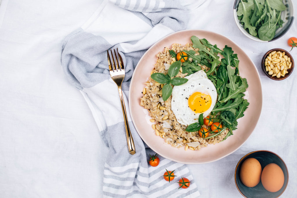 Savory Oatmeal with Arugula, Cherry Tomatoes + Pine Nuts