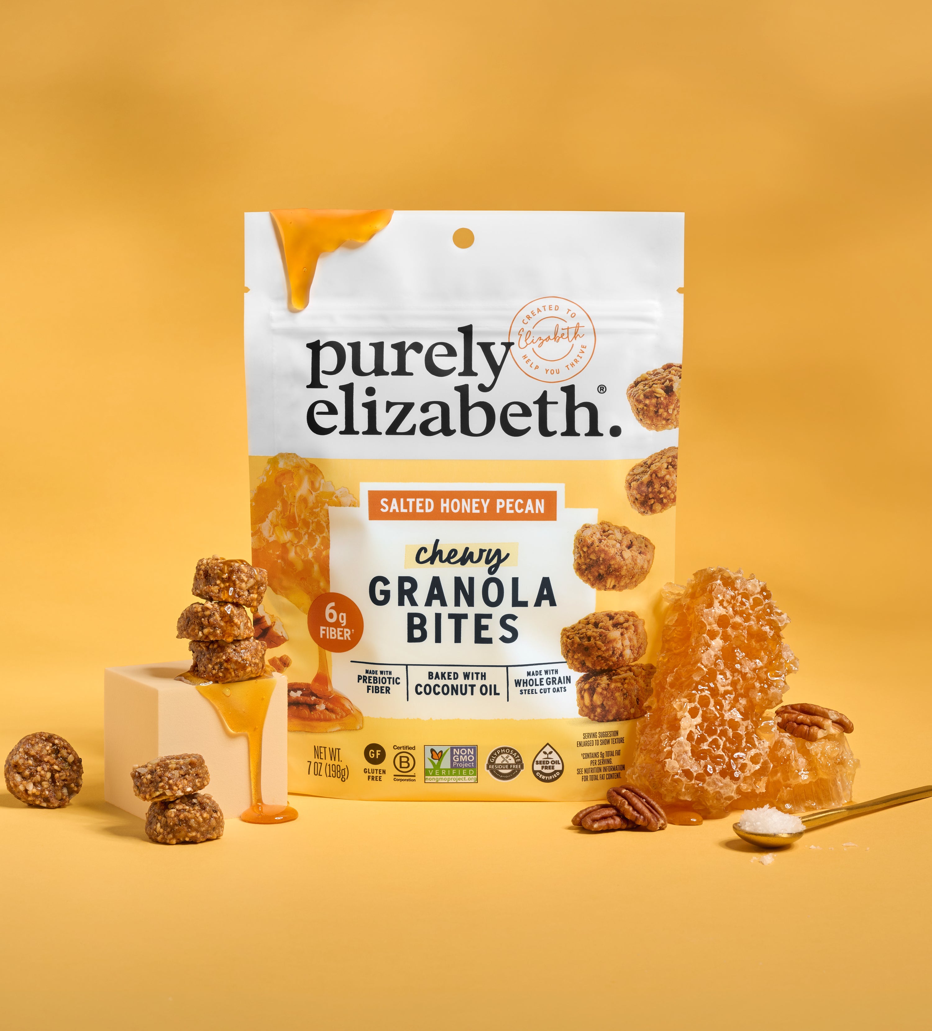 Purely Elizabeth Granola Bites Variety Pack bag with honey dripping down the side on a yellow backdrop