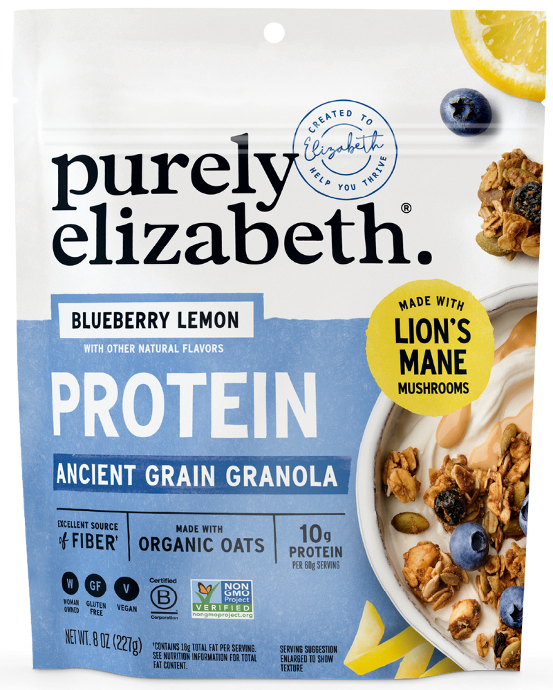 Purely Elizabeth Blueberry Lemon Protein Granola bag with a lemon slice and blueberries beside a bowl of granola.